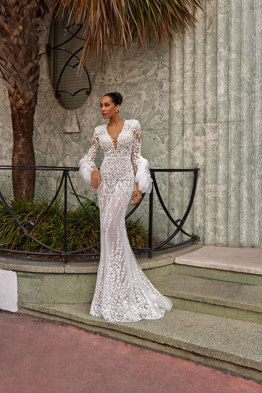 Elegant gown with lining displayed on a model in a stylish outdoor setting, showcasing intricate details and a fashionable design.