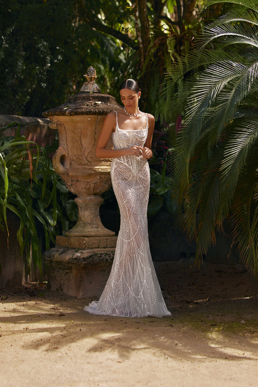 Luxurious wedding dress with lining showcased in a lush garden setting with intricate lace and shimmering details.