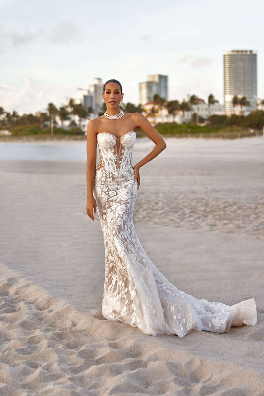 Modern fitted dress with lining on a beach, featuring a corset design and elegant detailing.