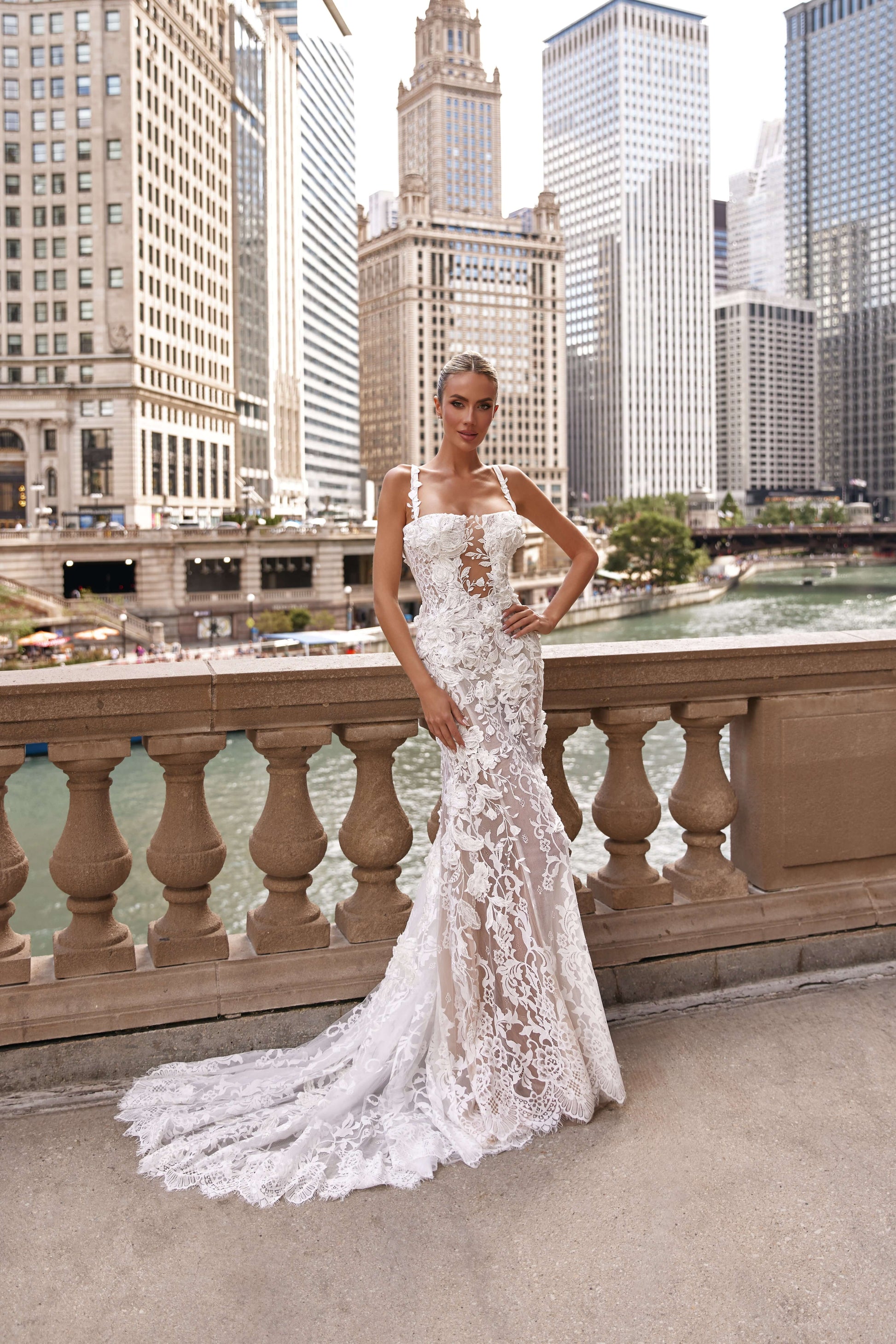 Chloe lined dress worn by model with urban skyline in background, showcasing a fitted silhouette and intricate lace details.