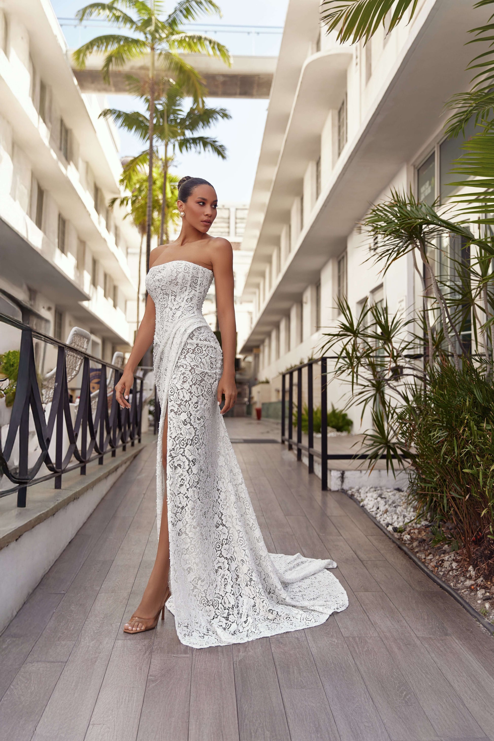 Stylish model wearing a modern wedding dress elegance with lace details in an outdoor setting.